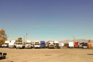 A group of trucks parked in a parking lot.