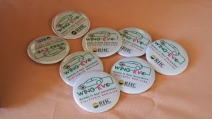 A group of buttons with a Wing-EV logo on them.