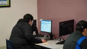 A person working on a computer in an office environment.