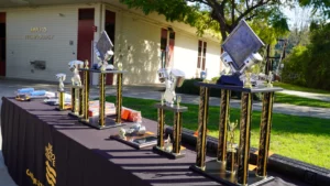 Trophies and awards displayed on a table at an applied technology event.